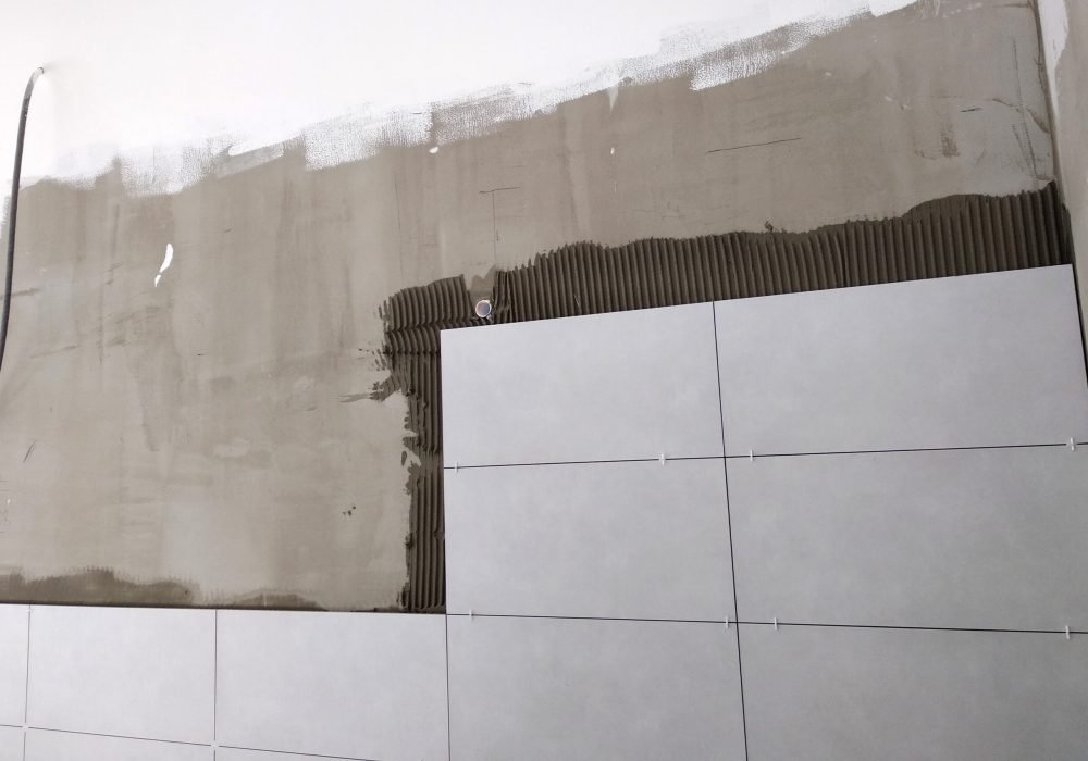 Wall ceramic tiles installation on mortar glue.